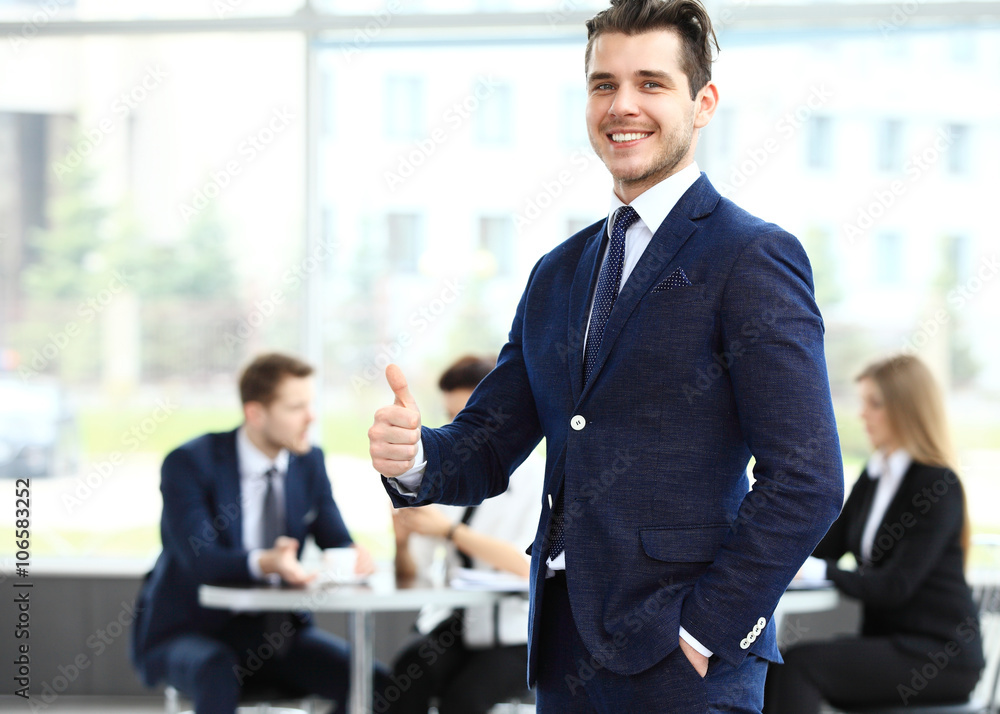 Businessman showing OK sign with thumb up. Businessman showing OK sign with thumb up.