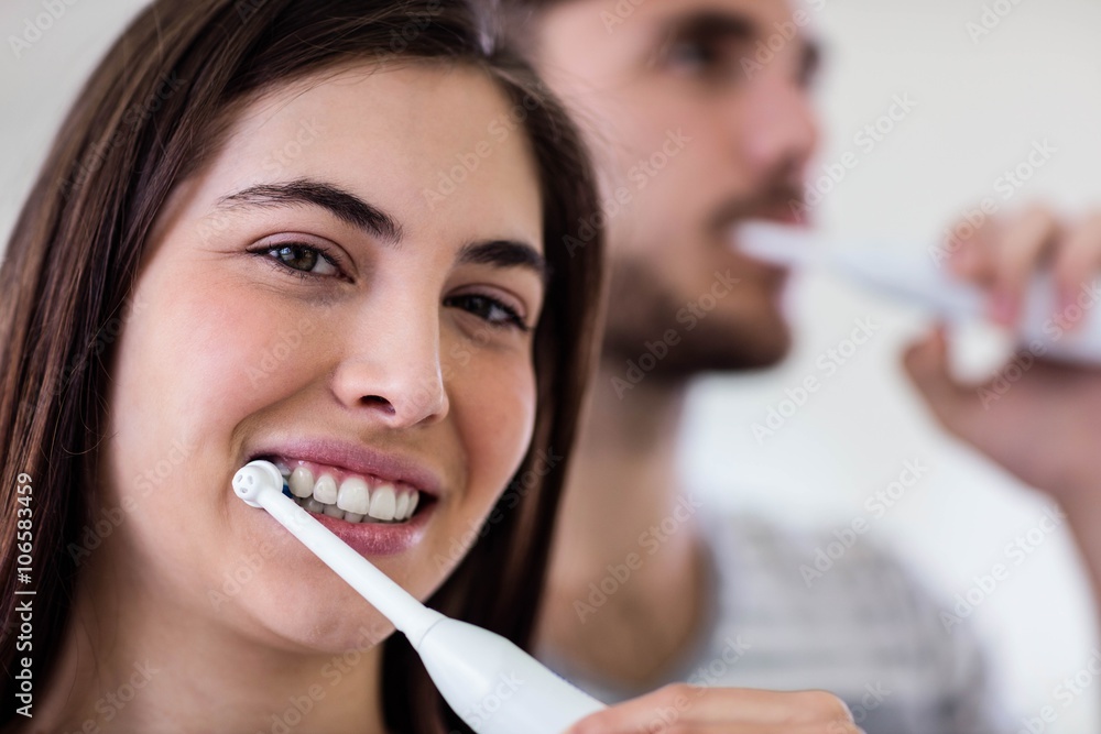 Couple brushing their teeth Couple brushing their teeth