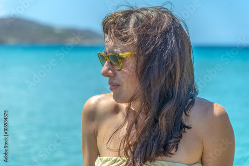 Portrait of a beautiful young woman enjoying the sun during summ