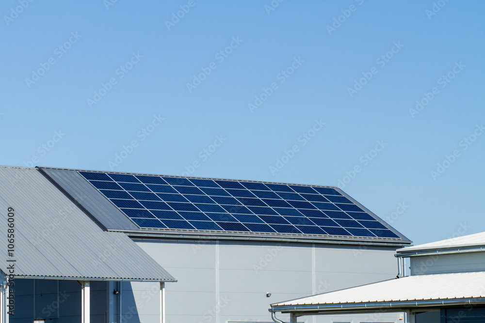 Fototapeta premium solar panels on large roof, factory building
