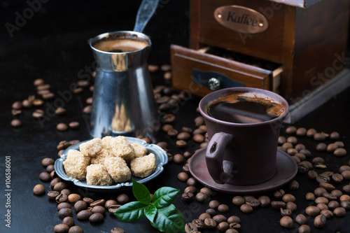 Cup of coffee, grinder and coffee beans