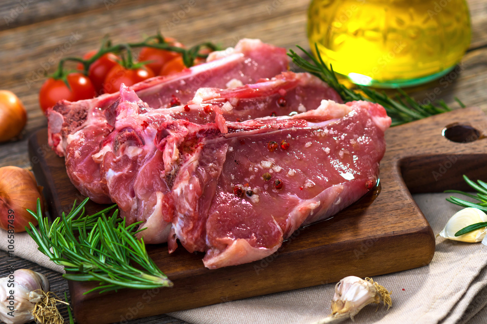 Raw veal steak  on wooden background
