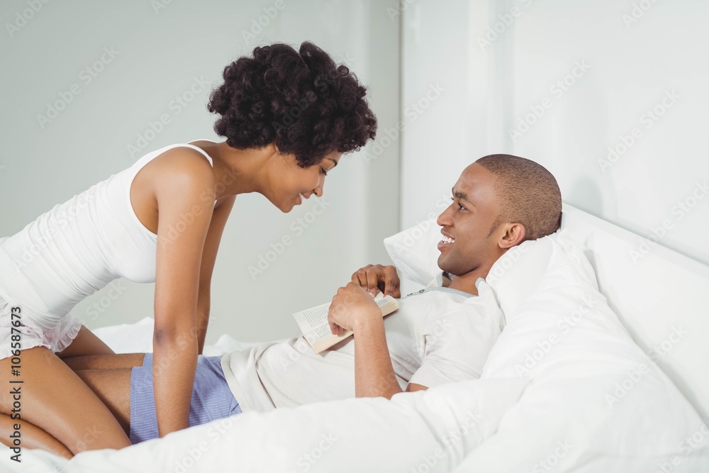 Fototapeta premium Happy couple reading on the bed