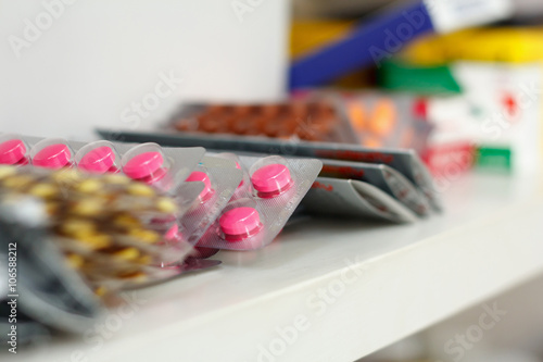 medicine pills on pharmacy shelf