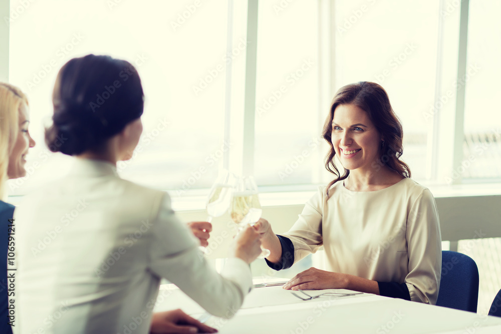 happy women drinking champagne at restaurant happy women drinking champagne at restaurant