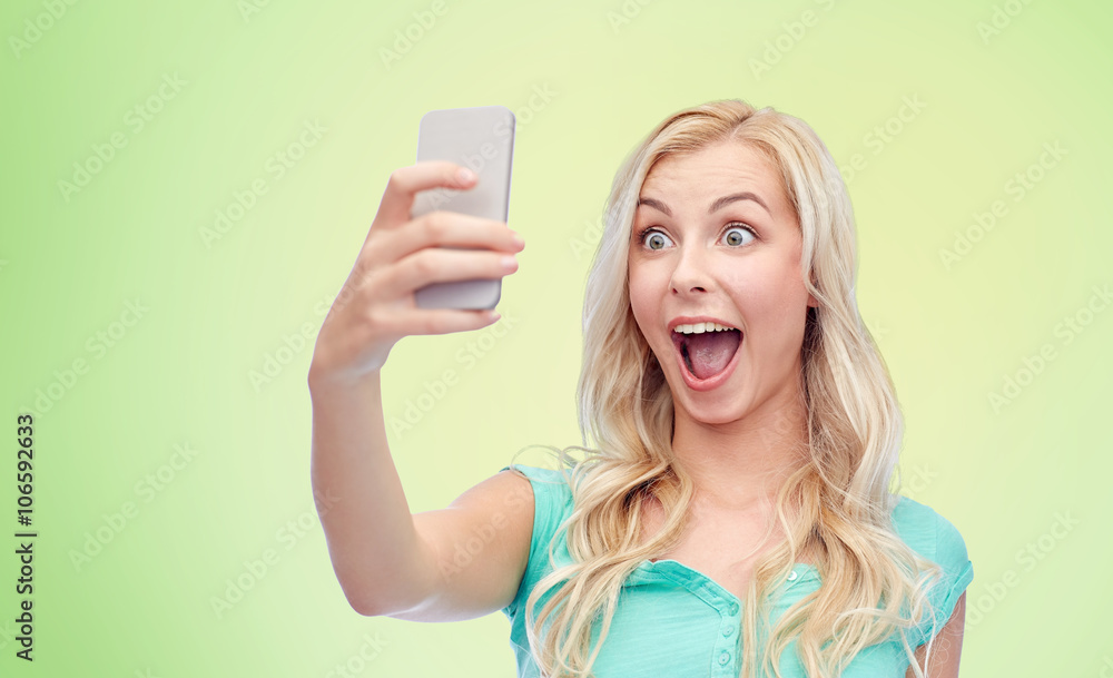 smiling young woman taking selfie with smartphone smiling young woman taking selfie with smartphone
