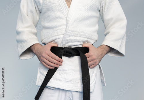 Martial arts Master with black belt in white kimono