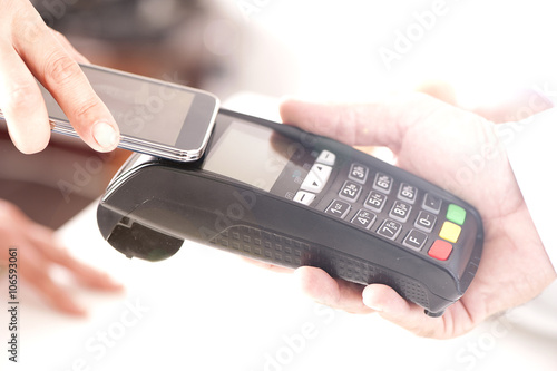 Paying with NFC technology on mobile phone  photo