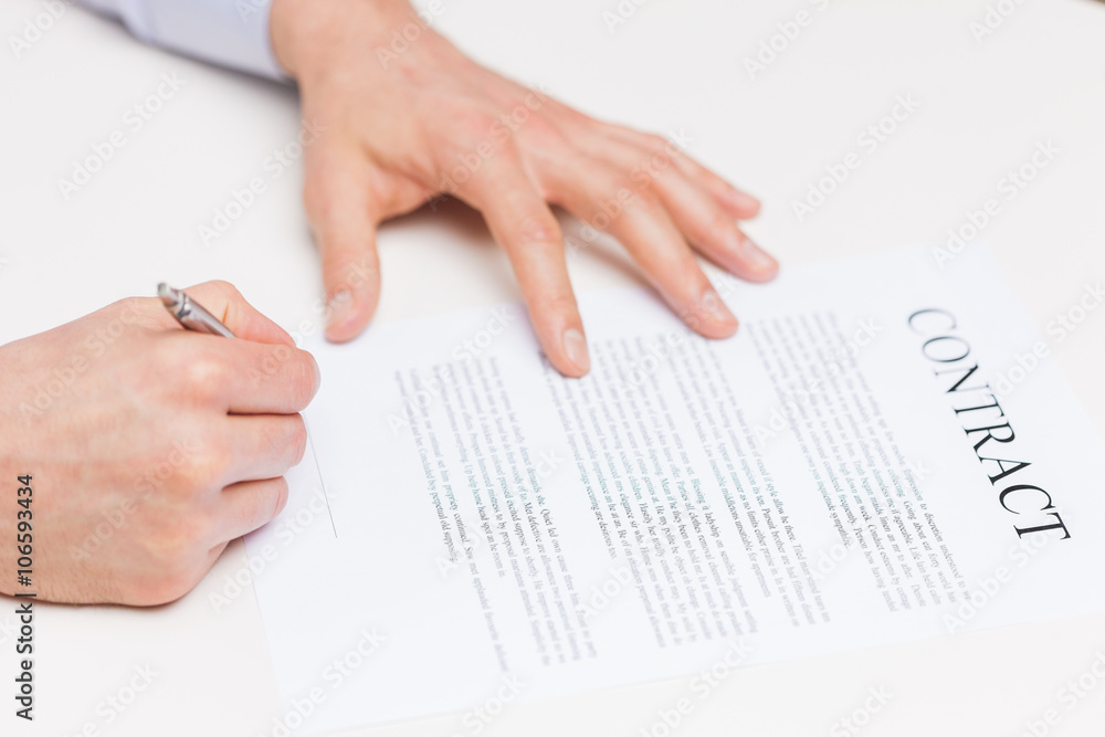 close up of male hands signing contract document close up of male hands signing contract document