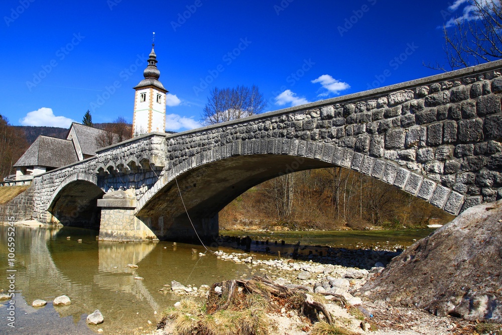 Old stone bridge on river Sava Bohinjka in Slovenia