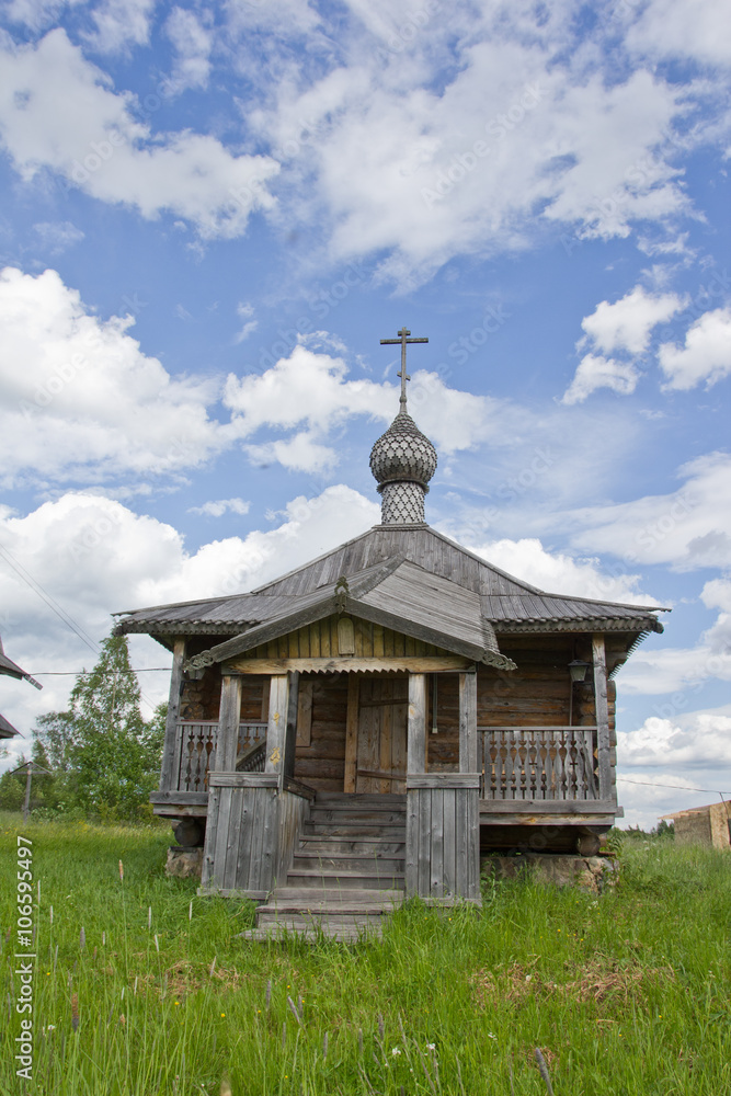 the wooden Orthodox Russian Church in the background of cloudy sky
