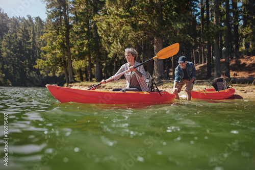 Mature couple having fun kayaking in the lake