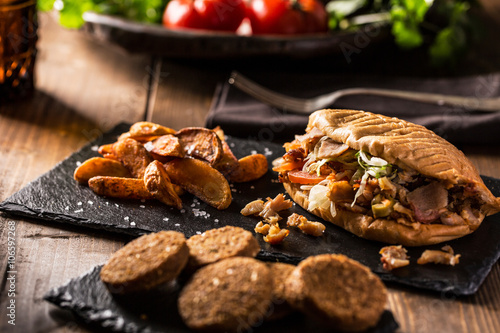 Doner kebab with fried potato on table