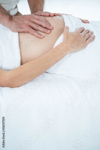 Pregnant woman receiving a stomach massage 