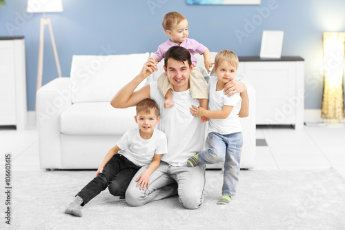 Family concept. Father with sons are playing in the room