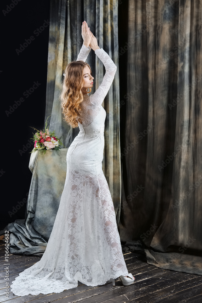 portrait of pretty bride in wedding dress with hands up portrait of pretty bride in wedding dress with hands up