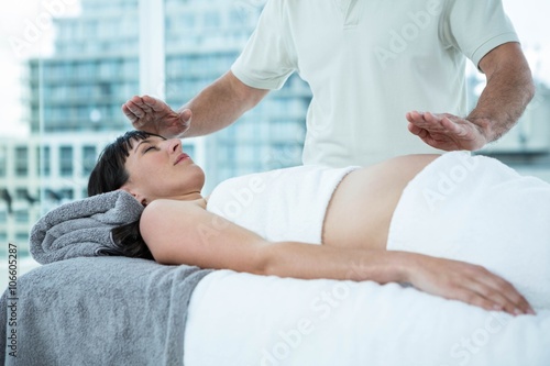 Pregnant woman receiving a massage from masseur