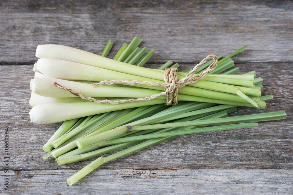 Fresh lemongrass (citronella) on wooden background - Spice for h