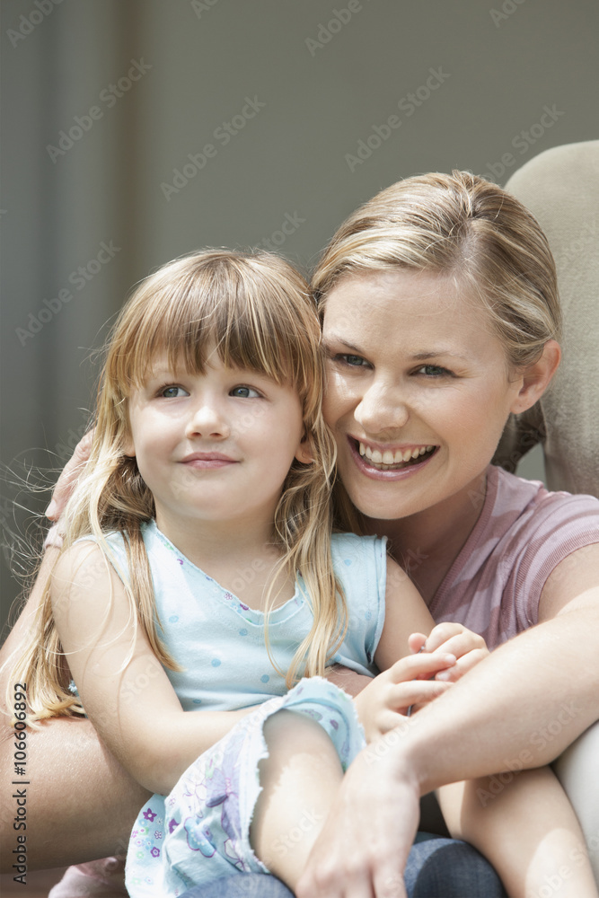 Caucasian mother and daughter laughing outdoors Caucasian mother and daughter laughing outdoors