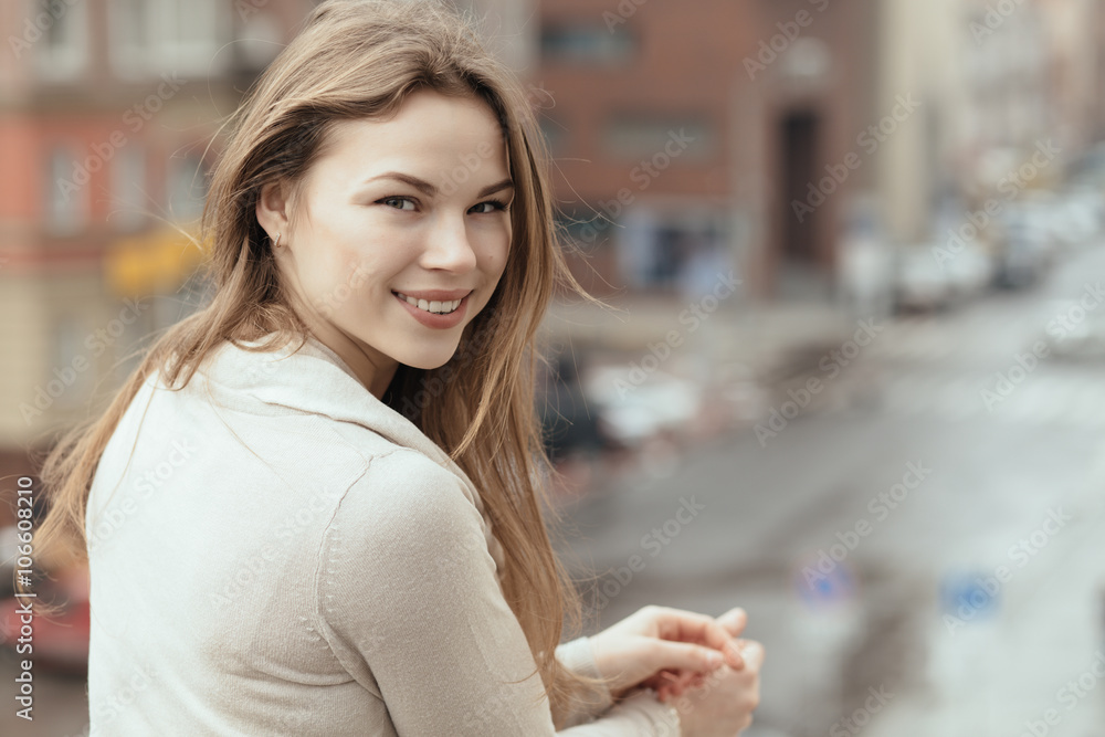 Young smiling woman in city