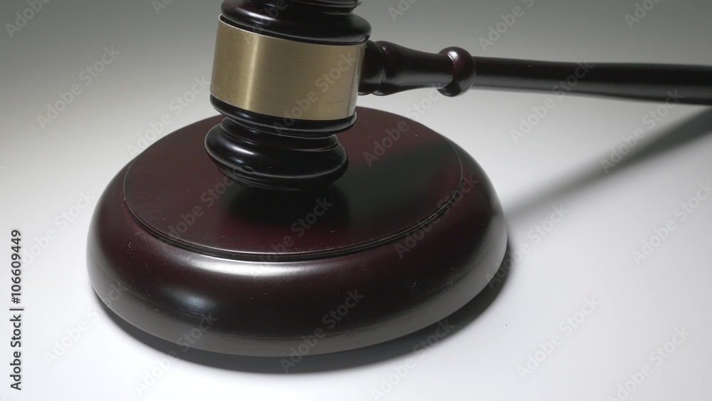 Dolly shot of a wooden judge gavel and soundboard isolated on white background. Dolly shot of a wooden judge gavel and soundboard isolated on white background.