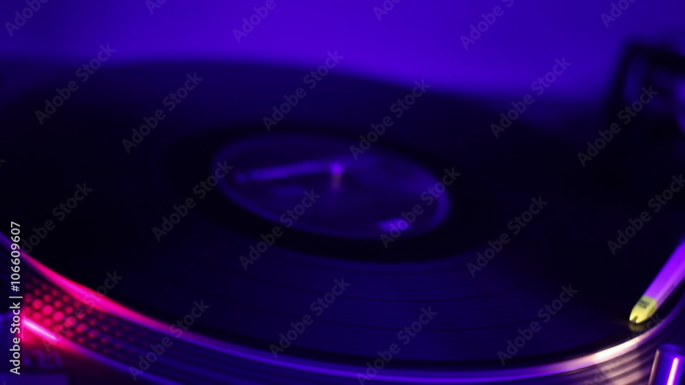 Vinyl record playing and turning around. Night club atmosphere. Audio equipment Vinyl record playing and turning around. Night club atmosphere. Audio equipment