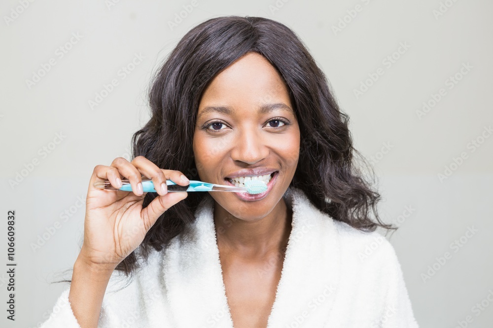 Portrait of a young woman brushing her teeth Portrait of a young woman brushing her teeth