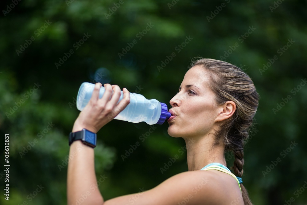 Marathon female athlete running drinking water Marathon female athlete running drinking water