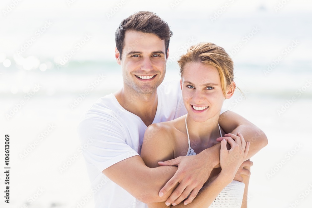 Portrait of young couple embracing each other on the beach Portrait of young couple embracing each other on the beach