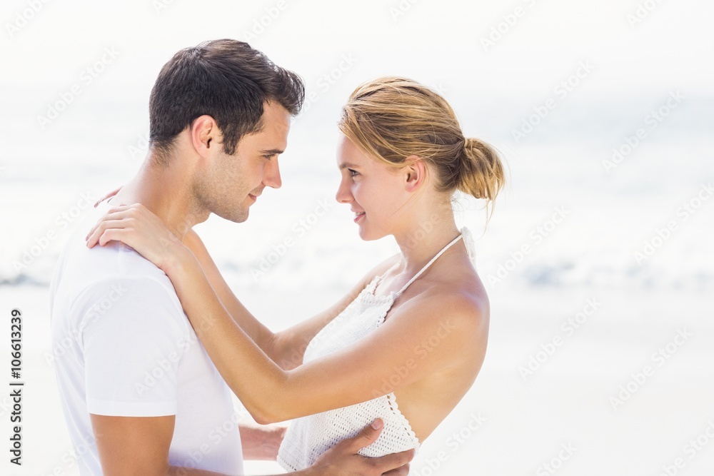 Young couple standing face to face and romancing Young couple standing face to face and romancing