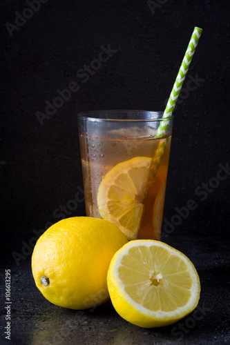 Ice tea with lemon. Black stone
