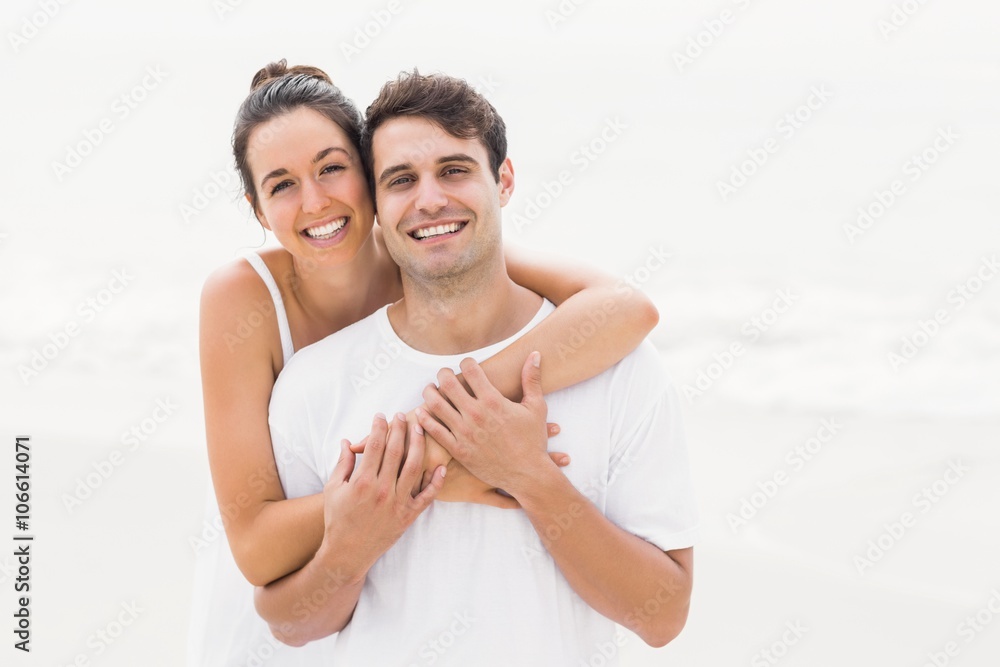 Portrait of young couple embracing each other on the beach Portrait of young couple embracing each other on the beach