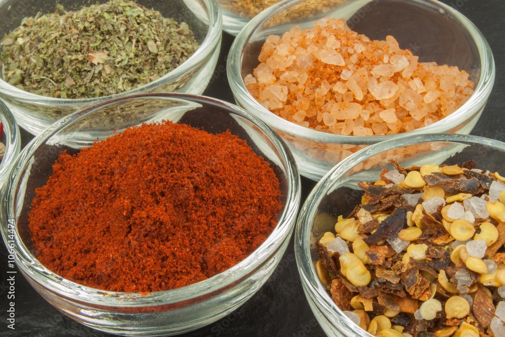 Various kinds of spices in glass bowls on a slate background. Preparation for cooking spicy food. Spices for master cook. The spice trade. Sale of spices in the kitchen.
Various kinds of spices in glass bowls on a slate background. Preparation for cooking spicy food. Spices for master cook. The spice trade. Sale of spices in the kitchen.