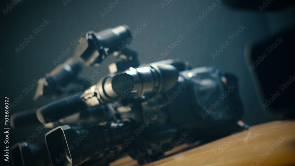 Сameraman prepares his professional  video camera for an urgent, rapid shooting