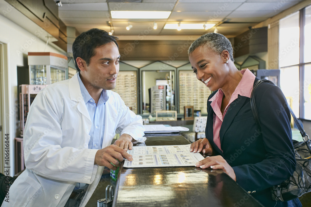 Optometrist talking to patient in office Optometrist talking to patient in office