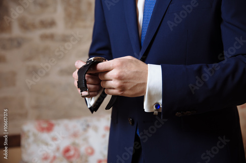 Man put the clock on his hand