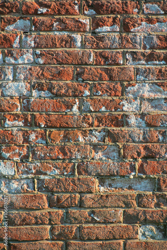 Vertical image of a aged red brick wall of a historical building