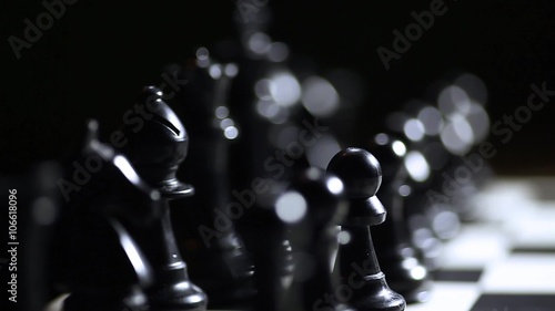 Arrangement of black chess pieces on chess board.