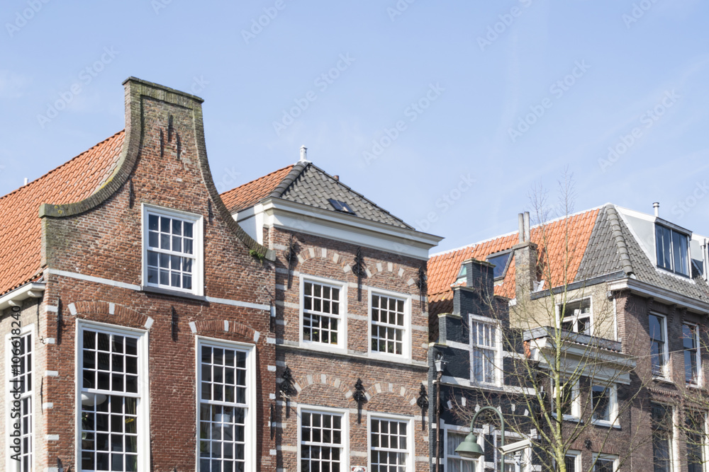 A skyline of vintage buildings roofs in the old downtown of Delft, Netherlands.