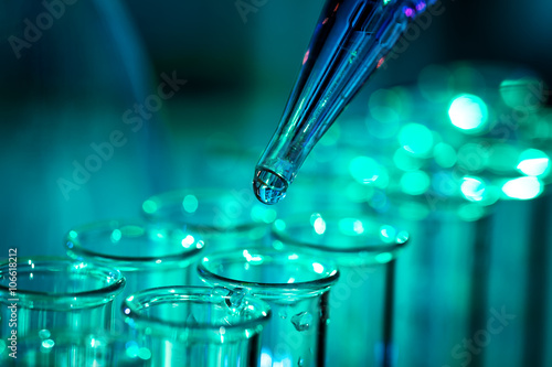 Pipette adding fluid to one of several test tubes