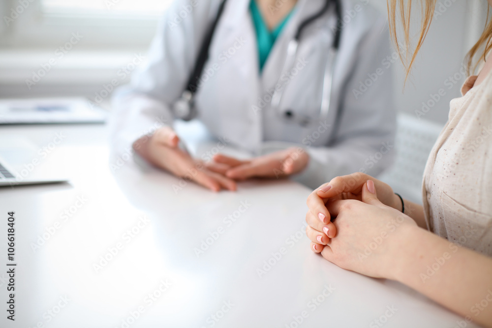 Doctor and patient are discussing something, just hands at the table Doctor and patient are discussing something, just hands at the table