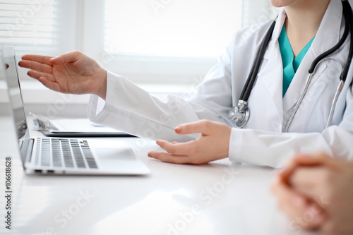 Doctor and patient are discussing something  just hands at the table