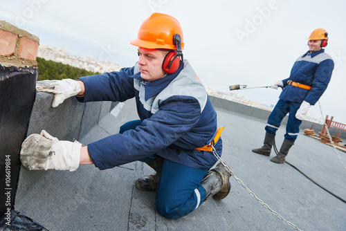 Obraz na płótnie Flat roof installation. Heating and melting bitumen roofing felt