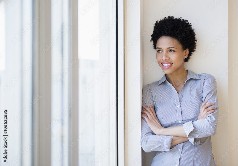 Black businesswoman smiling by window Black businesswoman smiling by window