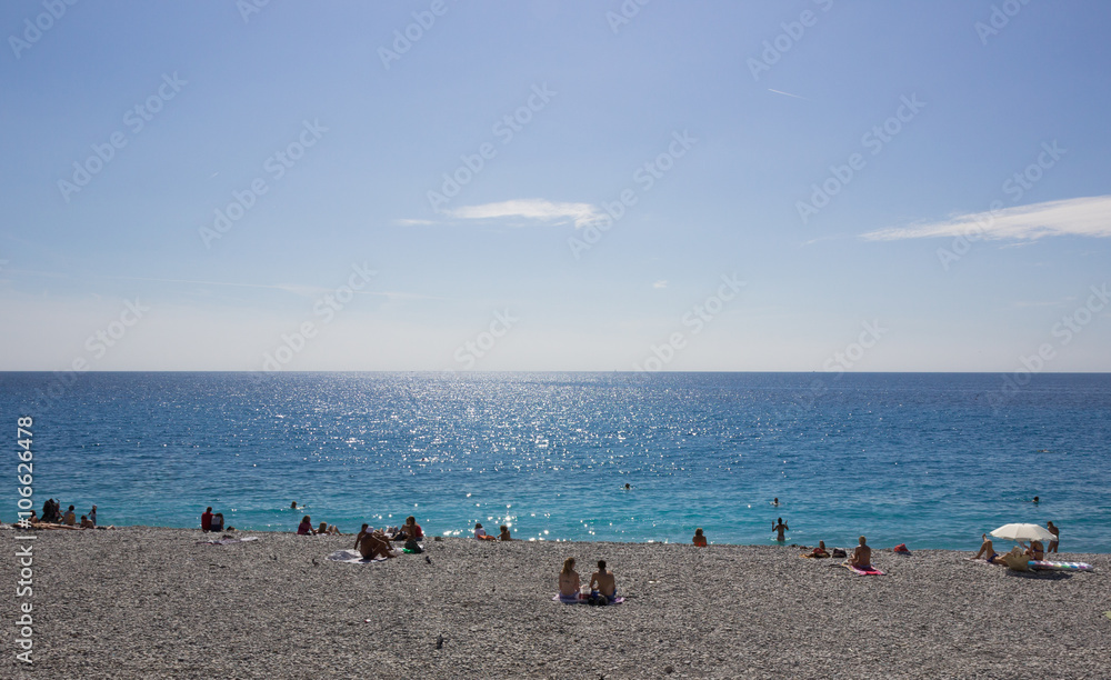 People sunbathing on the Cote d'Azur in Nice, France People sunbathing on the Cote d'Azur in Nice, France