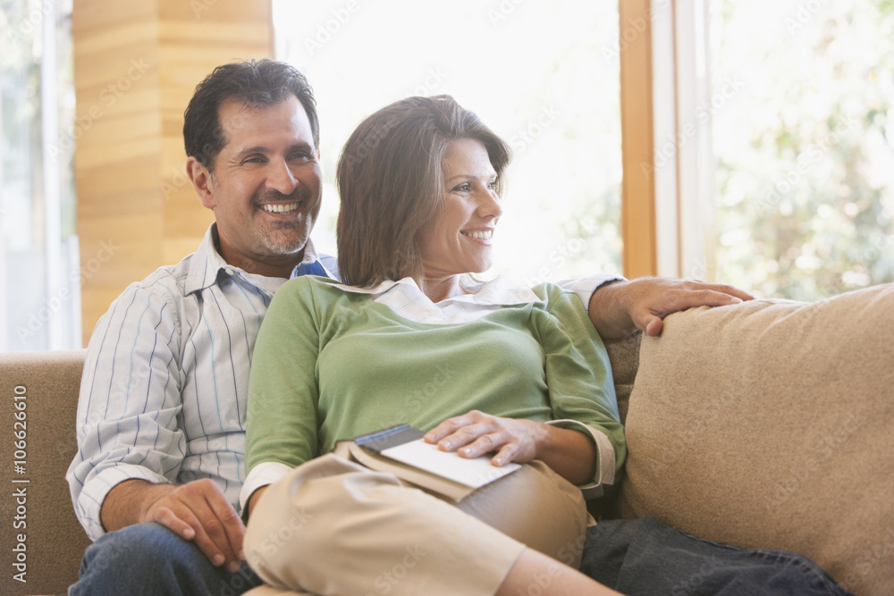 Hispanic couple relaxing on sofa Hispanic couple relaxing on sofa