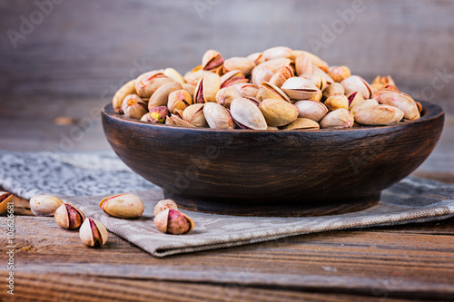 Almonds  on a wooden bowl. Selective focus.