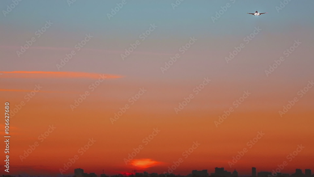 Airplane approaching at dawn Airplane approaching at dawn