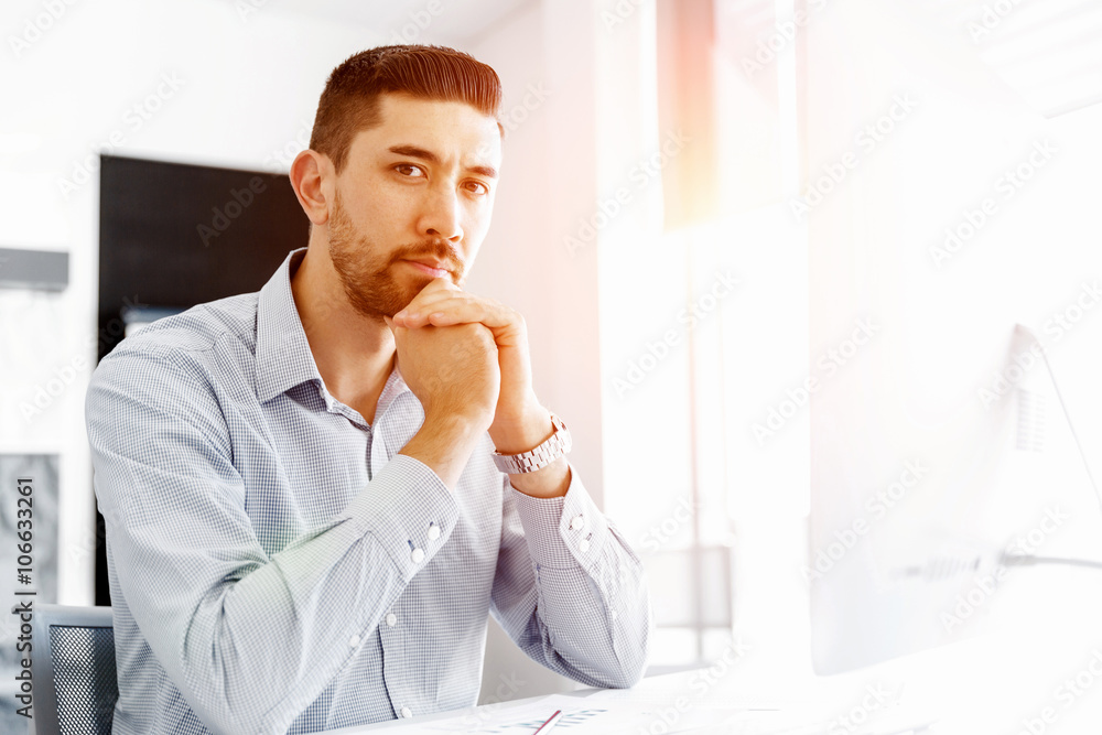 Attractive office worker sitting at desk Attractive office worker sitting at desk