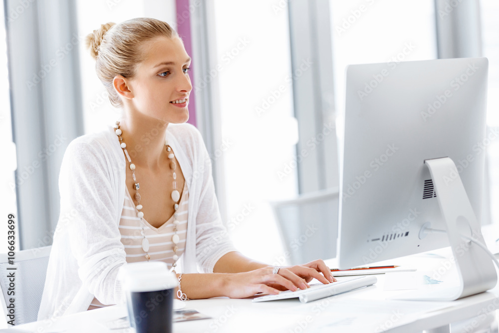Attractive office worker sitting at desk Attractive office worker sitting at desk